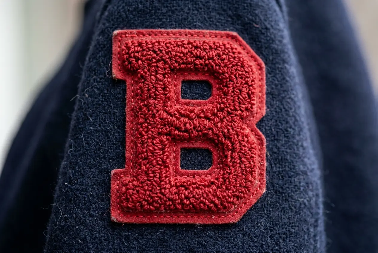 Red chenille varsity letter on a navy felt background